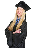 Portrait of happy young woman in graduation gown