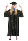 Full length portrait of happy young woman in graduation gown poi