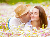 Two lovers on floral meadow