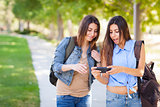Young Adult Mixed Race Twin Sisters Sharing Cell Phone Experienc
