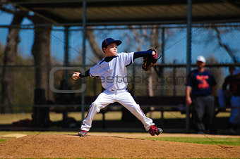 Youth baseball pitcher in wind up