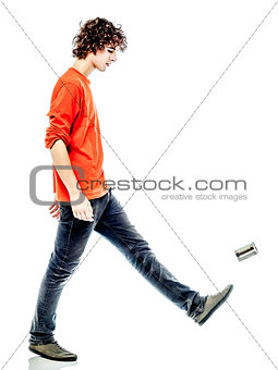 young man walking kicking tin can  side view