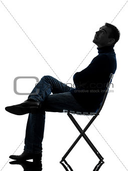 man sitting looking up  silhouette full length