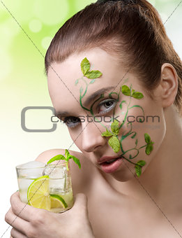 cute girl with fresh make-up drinking cocktail
