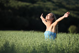 Beautiful teenager girl laughing in a green meadow