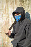 Man with a machete on a old wall background
