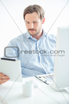 Businessman checking his work at tablet