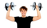 Portrait of a smiling athletes lifting weights