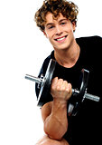 Athlete doing exercise with dumbbell