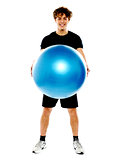 Male fitness trainer holding a pilate ball