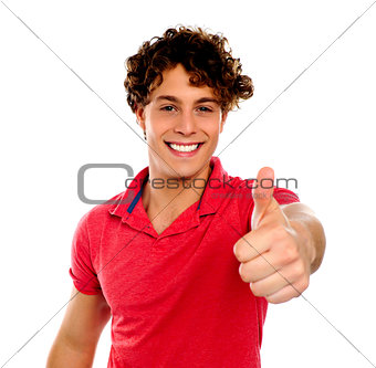 Handsome young man gesturing thumbs-up