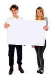 Adorable young couple promoting blank banner ad