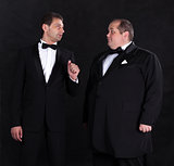 Two stylish businessman in tuxedos