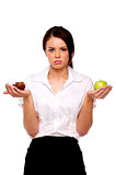 Business woman comparing an apple to cake