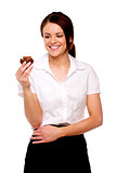 Business woman looking at a chocolate bun