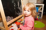 Girl paints at the easel