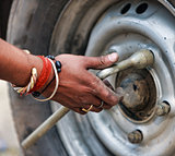 Man changing the car wheel on the road,  close up