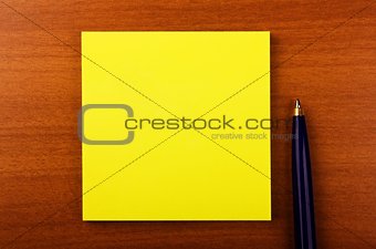 Sticker with pen on wooden background