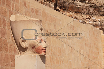 Face in ancient stone column