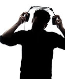 Male in silhouette putting headphones