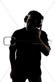 Male in silhouette listening to headphones