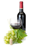 Red wine glass, bottle and grapes