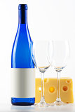 Blue bottle of white wine, two wine glasses and cheese