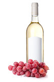 White wine in bottle and red grapes