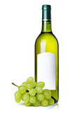 White wine in green bottle with blank label and grapes