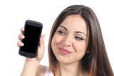 Sweet woman showing a blank mobile phone screen 