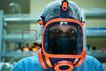 Portrait of woman working in scientific lab wearing gas mask