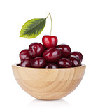 Ripe cherries in a wooden bowl