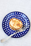 Sweet cottage cheese pancakes on a plate with stars and a fork