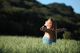 Beautiful woman breathing happy in a green meadow