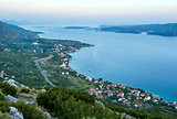Sea sunset and village  on seashore (PeljeÅ¡ac  peninsula, Croat