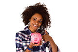 Female afro american with piggy bank