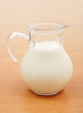 Glass jug full of milk