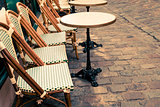 Street view of a coffee terrace with tables and chairs