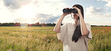Young woman watching with binocular