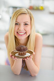 Portrait of smiling smiling teenager girl holding chocolate muff