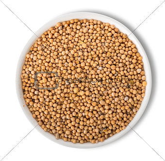 Mustard seeds in plate isolated