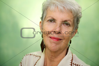 Portrait of old caucasian lady looking and smiling at camera