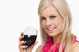 Smiling blonde drinking a glass of wine