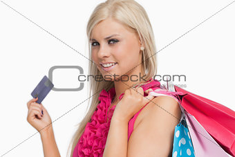 Smiling blonde holding credit card