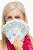 Beautiful blonde holding 100 euros banknotes