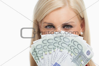 Pretty blonde holding 100 euros banknotes