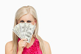Woman hiding her face with 100 dollars banknotes