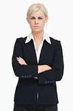 Serious blond businesswoman arms crossed