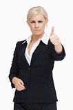 Serious blond businesswoman thumb-up