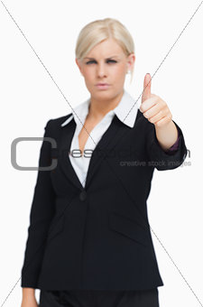 Serious blonde businesswoman thumb-up